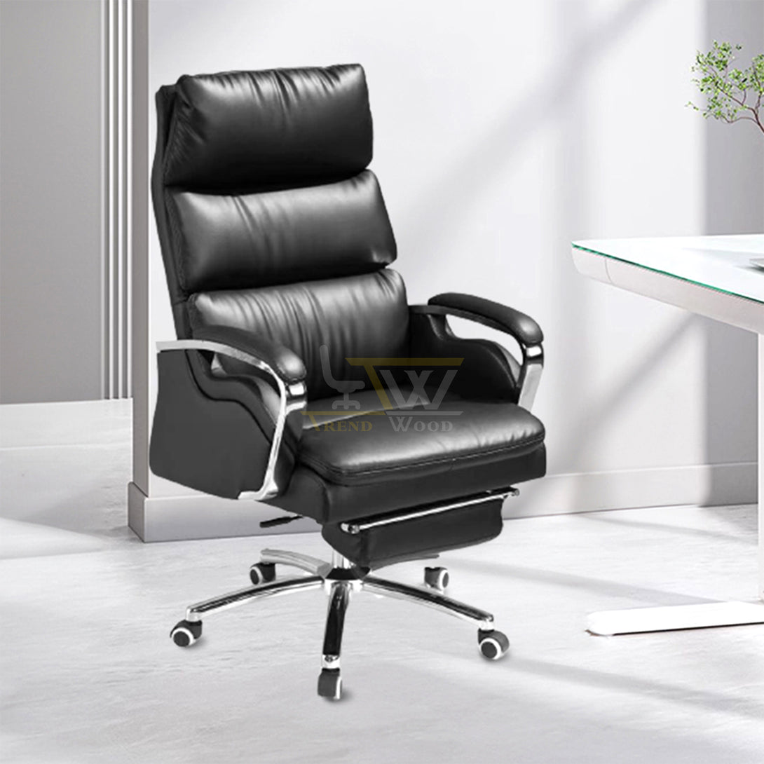 Trendwood black leather ergonomic executive chair with padded armrests and chrome base for modern Pakistani offices.