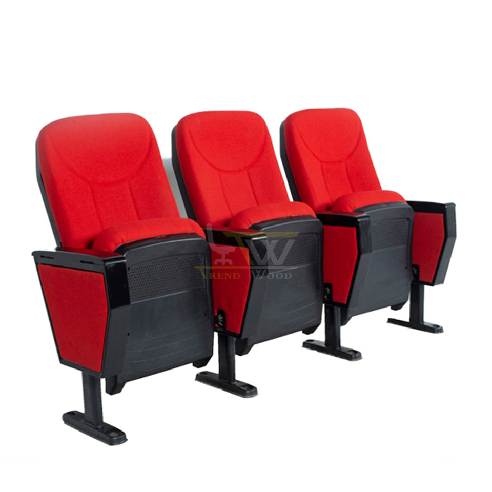 Row of red cushioned auditorium chairs with side armrests and black backing.